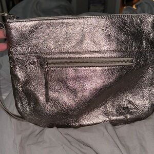 The Sak metallic gray crossbody with adjustable strap pocket on front and back